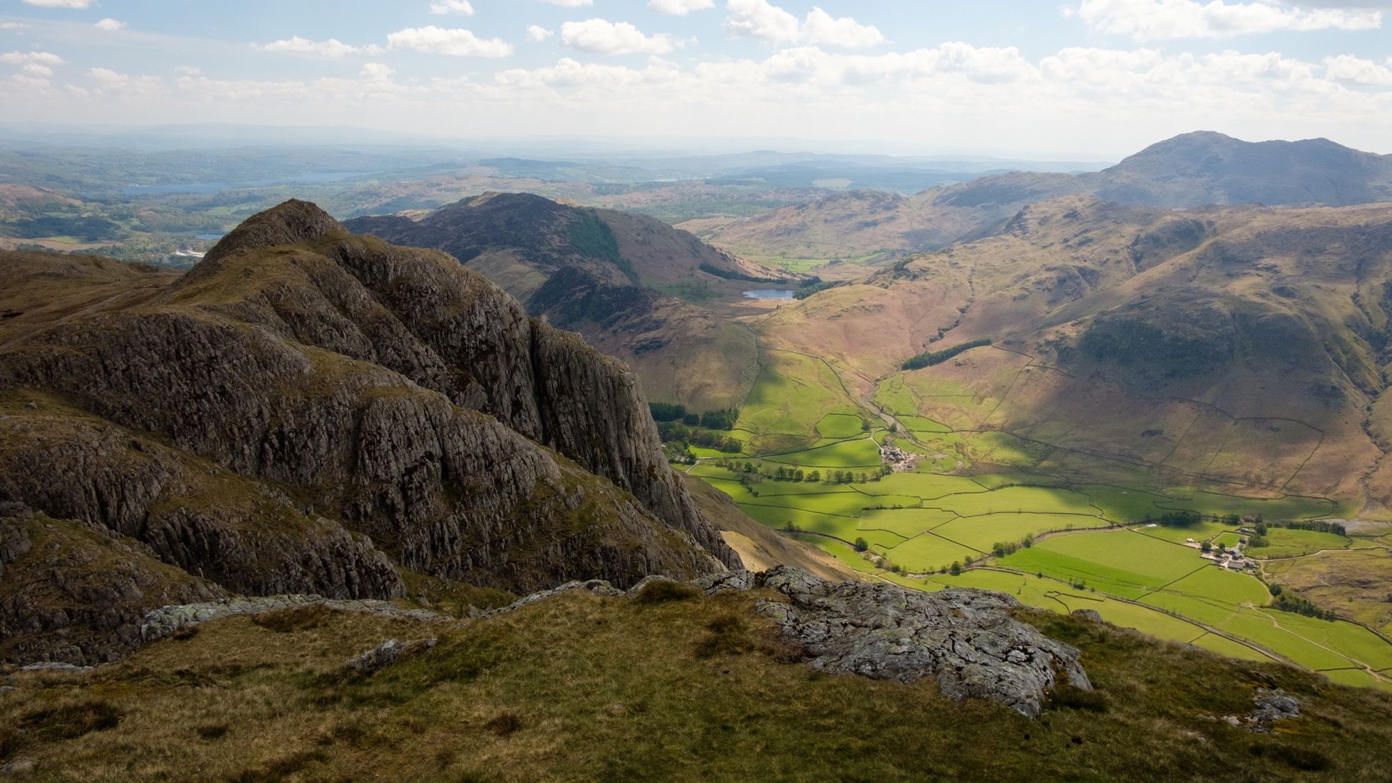The mighty Gimmer Crag looms over the fields of Langdale